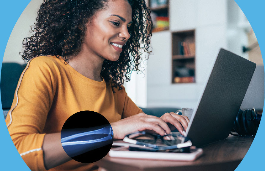 Image of African women typing on laptop with x-ray image of arm.